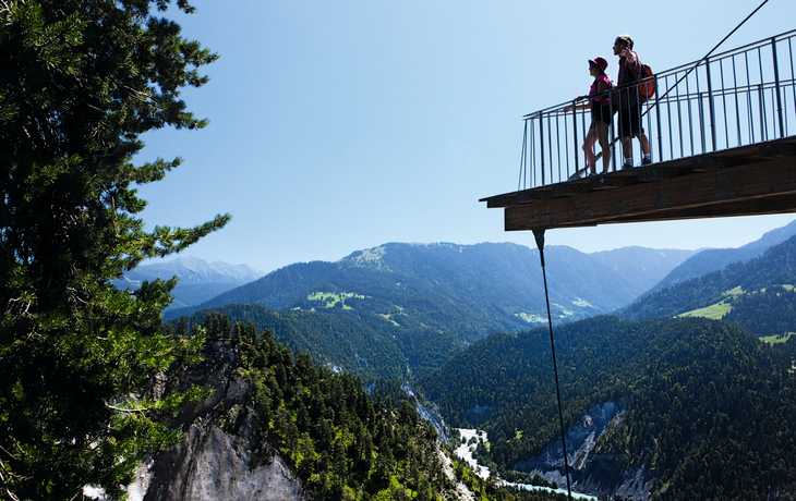 Aussichtsplattform Il Spir mit Blick auf die Rheinschlucht und umliegende Berge.