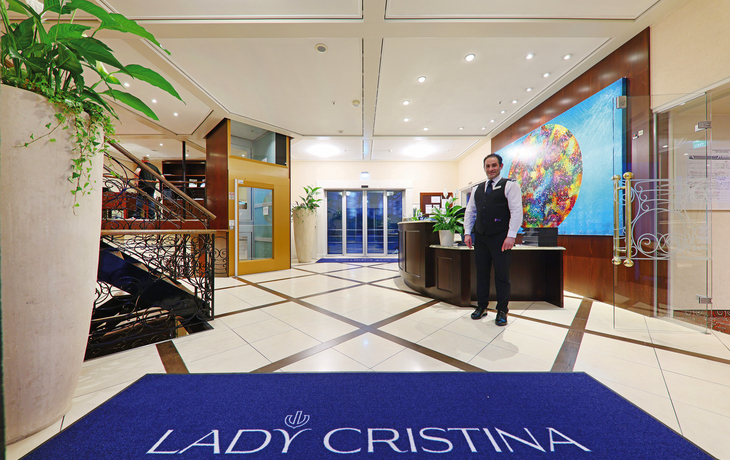 Rezeption auf Kreuzfahrtschiff mit Teppich und Empfangstresen